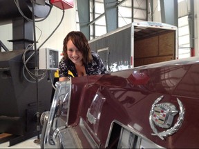 Marlena Meneses poses beside a Cadillac owned by Dellen Millard with a device known as "The Eliminator" in the background in a court exhibit photo released at the Laura Babcock murder trial in Toronto, Friday, Nov.17, 2017. THE CANADIAN PRESS/HO