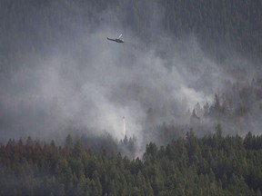 A helicopter dumps a load of water on the Philpot Road fire outside of Kelowna, B.C., Monday, August 28, 2017. The Canadian prairies top a newly developed index of places where wildfires could threaten freshwater supplies. THE CANADIAN PRESS/Jonathan Hayward