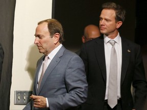 NHL Commissioner Gary Bettman, left, arrives at a news conference with new Phoenix Coyotes' co-owner George Gosbee before an NHL hockey game between the New York Rangers and the Coyotes, Thursday, Oct. 3, 2013, in Glendale, Ariz. Energy investment firm AltaCorp Capital Inc. says its founder and CEO, Calgary oil and gas financier George Gosbee, died suddenly on Sunday. THE CANADIAN PRESS/ AP/Ross D. Franklin