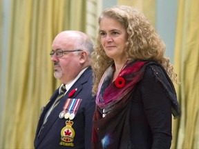 Governor General Julie Payette stands with the Dominion President of the Royal Canadian Legion Davi Flannigan after receiving the first poppy for the National Poppy campaign during a ceremony at Rideau Hall in Ottawa on October 23, 2017.