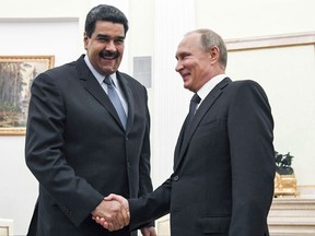 Venezuela's President Nicolas Maduro shakes hands with Russian President Vladimir Putin at the Kremlin in Moscow on Oct. 4, 2017.
