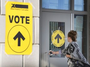 Stephane Perrault, the acting chief electoral officer, says Elections Canada must stay above the political fray and should not be perceived as being involved in anything that could influence the outcome of a campaign. A woman enters Maple High School in Vaughan, Ont., to cast her vote in the Canadian federal election on Monday, Oct. 19, 2015. THE CANADIAN PRESS/Peter Power