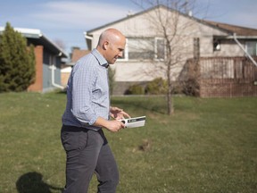 Alberta Party Leader Greg Clark goes door knocking while on the campaign trail in Edmonton, Alta., on Monday, April 27, 2015. THE CANADIAN PRESS/Jason Franson