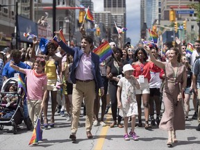 Prime Minister Justin Trudeau, his wife Sophie Gregoire Trudeau and their children Ella-Grace and Xavier walk in the Pride parade in Toronto on June 25, 2017. The New Democrats say the LGBTQ community needs Prime Minister Justin Trudeau to back up his apology for past state-sanctioned discrimination with reparations for the harm they suffered over decades. THE CANADIAN PRESS/Mark Blinch