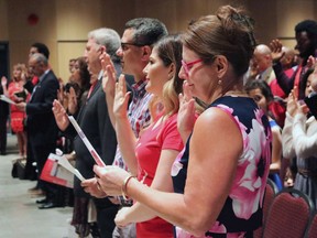 People take the citizenship oath at Pier 21 immigration centre in Halifax on July 1, 2017. An internal government survey of Canadians' perceptions of immigration suggests attitudes could be hardening. The Immigration Department polls Canadians every year ahead of putting together their annual plan on immigration. THE CANADIAN PRESS/Adina Bresge