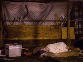 A homeless woman sleeps at a tent city at Oppenheimer Park in the Downtown Eastside of Vancouver Wednesday October 15, 2014.