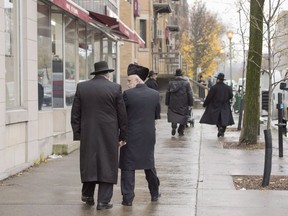 Hasidic Jewish men walk along Bernard Street in Outremont, in Montreal on Wednesday, November 16, 2016. The size of the country's Jewish community appears, on the surface, to have seen its most dramatic decline in decades, with newly released census data on the country's ethnic makeup suggesting a 56 per cent drop in numbers over a five-year period. THE CANADIAN PRESS/Ryan Remiorz