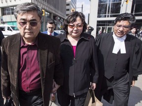 The Canadian man accused in a massive hack of Yahoo emails is set to appear in court today in San Francisco. Akhmet Tokbergenov, left, and Dinara Tokbergenova, parents of alleged Yahoo hacker Karim Baratov, leave the court after their son was denied bail, with lawyer Deepak Paradkar, right, in Hamilton, Ont., on Tuesday, April 11, 2017. THE CANADIAN PRESS/Mark Blinch