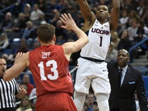 Connecticut's Christian Vital shoots over Boston University's Will Goff during the first half of an NCAA college basketball game, Sunday, Nov. 19, 2017, in Hartford, Conn. (AP Photo/Jessica Hill)