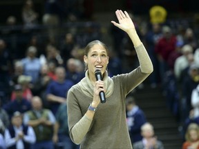 Former Connecticut basketball great Rebecca Lobo waves to the crowd after receiving her Naismith Basketball Hall of Fame ring during a ceremony prior to an NCAA college basketball game between Connecticut and California, Friday, Nov. 17, 2017, in Storrs, Conn. (AP Photo/Stephen Dunn)