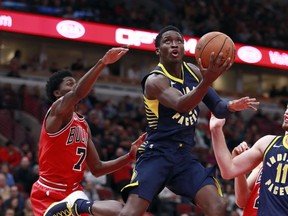 Indiana Pacers guard Victor Oladipo goes in for a lay-up past Chicago Bulls guard Justin Holiday (7) during the first half of an NBA basketball game in Chicago, on Friday Nov. 10, 2017. (AP Photo/Jeff Haynes)