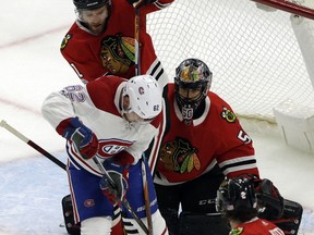 Montreal Canadiens left wing Arthur Lehkonen (62) shoots against Chicago Blackhawks goalie Corey Crawford and defenseman Cody Franson during the first period of an NHL hockey game, Sunday, Nov. 5, 2017, in Chicago. (AP Photo/Nam Y. Huh)