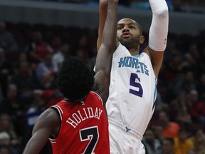 Charlotte Hornets' Nicolas Batum, right, shoots over Chicago Bulls' Justin Holiday during the first half of an NBA basketball game Friday, Nov. 17, 2017, in Chicago. (AP Photo/Jim Young)