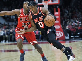 Miami Heat's Josh Richardson (0) drives against Chicago Bulls' Kris Dunn (32) during the first half of an NBA basketball game, Sunday, Nov. 26, 2017, in Chicago. (AP Photo/Paul Beaty)