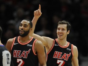 Miami Heat's Goran Dragic (7), of Slovenia, and Wayne Ellington (2) celebrate after Dragic made a basket while being fouled during the final minutes of the second half of an NBA basketball game against the Chicago Bulls, Sunday, Nov. 26, 2017, in Chicago. (AP Photo/Paul Beaty)