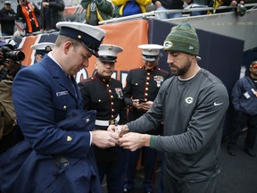 Green Bay Packers' Aaron Rodgers signs autographs for the members of the U.S. Coast Guard and U.S. Marine before an NFL football game against the Chicago Bears, Sunday, Nov. 12, 2017, in Chicago. (AP Photo/Charles Rex Arbogast)