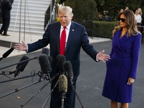 First lady Melania Trump looks on as President Donald Trump speaks with reporters before departing the White House for a trip to Asia, Friday, Nov. 3, 2017, in Washington. (AP Photo/Evan Vucci)