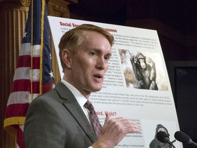 Sen. James Lankford, R-Okla., a member of the Senate Appropriations Committee, holds a news conference to outline the release of his report on wasteful spending in the federal government, on Capitol Hill in Washington, Monday, Nov. 27, 2017. Lankford stands beside a chart that points to the expense of feed and care for chimpanzees that were used for medical research. (AP Photo/J. Scott Applewhite)