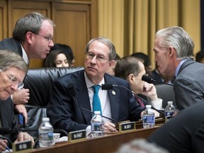 House Judiciary Committee Chairman Bob Goodlatte, R-Va., center, is joined by, from left, Rep. Lamar Smith, R-Texas, a staff aide, and Rep. Trey Gowdy, R-S.C., far right, as the panel meets to craft a Republican bill to expand gun owners' rights, the first gun legislation since mass shootings in Las Vegas and Texas killed more than 80 people, on Capitol Hill in Washington, Wednesday, Nov. 29, 2017. (AP Photo/J. Scott Applewhite)