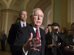 Senate Majority Leader Mitch McConnell, R-Ky., joined at rear by Sen. John Thune, R-S.D., tells reporters that he has spoken to President Donald Trump and other leaders about the Alabama Senate race and the allegations of sexual misconduct against GOP candidate Roy Moore, on Capitol Hill in Washington, Tuesday, Nov. 14, 2017. McConnell and other Republicans have called for Moore to step aside. (AP Photo/J. Scott Applewhite)