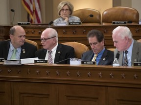 Republican members of the House Ways and Means Committee, from left, Rep. Tom Reed, R-NY, Rep. Mike Kelly, R-Pa., Rep. Jim Renacci, R-Ohio, and Rep. Pat Meehan, R-Pa., with Rep. Diane Black, R-Tenn., at top, work on the markup of the GOP's far-reaching tax overhaul, on Capitol Hill in Washington, Monday, Nov. 6, 2017. (AP Photo/J. Scott Applewhite)