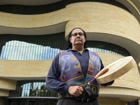 Dennis Zotigh poses for a photo outside the National Museum of the American Indian in Washington, Friday, Nov. 3, 2017.  Many tribes even have their own national anthems known as flag songs that focus on veterans. They're popular among Plains tribes from which the modern powwow originated, said Zotigh of the Smithsonian National Museum of the American Indian. Powwows are social gatherings, generally with competitive dancing.  (AP Photo/Susan Walsh)