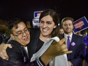 Danica Roem, who ran for house of delegates against GOP incumbent Robert Marshall, is greeted by supporters as she prepares to give her victory speech with Prince William County Democratic Committee at Water's End Brewery on Tuesday, Nov. 7, 2017, in Manassas, Va. Roem will be the first openly transgender person elected and seated in a state legislature in the United States. (Jahi Chikwendiu/The Washington Post via AP)