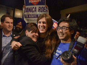 Danica Roem, center, who ran for house of delegates against GOP incumbent Robert Marshall, is greeted by supporters as she prepares to give her victory speech with Prince William County Democratic Committee at Water's End Brewery on Tuesday, Nov. 7, 2017, in Manassas, Va. Roem will be the first openly transgender person elected and seated in a state legislature in the United States. (Jahi Chikwendiu/The Washington Post via AP)