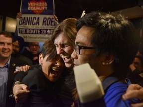 Danica Roem, center, a Democrat who ran for Virginia's House of Delegates against GOP incumbent Robert Marshall, is greeted by supporters as she prepares to give her victory speech Tuesday, Nov. 7, 2017, in Manassas, Va. Roem, a former journalist, is set to make history as the first openly transgender person elected and seated in a state legislature in the United States. (Jahi Chikwendiu/The Washington Post via AP)