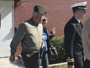 FILE - In this Oct., 31, 2017 file photo, U.S. Marine Gunnery Sgt. Joseph A. Felix, his wife, and his lawyers exit a courtroom after testimony at Camp Lejeune, N.C.  Closing arguments could begin soon for a former Felix, a Marine Corps drill instructor facing court-martial on charges including cruelty and maltreatment. Prosecutors have spent more than a week at Camp Lejeune in North Carolina laying out the case against Felix. They returned to court Wednesday, Nov. 8. (Rory Laverty /The Washington Post/via AP, File)