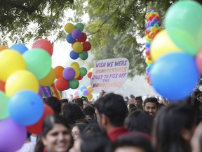 Gay rights activists and their supporters hold colorful balloons and placards as they participate in a gay pride parade in New Delhi, India, Sunday, Nov. 12, 2017. (AP Photo)