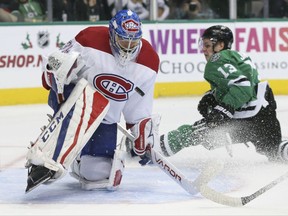 Montreal Canadiens goalie Charlie Lindgren (39) blocks a shot against Dallas Stars center Mattias Janmark (13) during the first period of an NHL hockey game in Dallas, Tuesday, Nov. 21, 2017. (AP Photo/LM Otero)