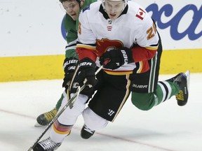 Calgary Flames center Freddie Hamilton (25) skates with the puck against Dallas Stars center Mattias Janmark (13) during the first period of an NHL hockey game in Dallas, Friday, Nov. 24, 2017. (AP Photo/LM Otero)