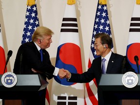 U.S. President Donald Trump, left, shakes hands with Moon Jae-in, South Korea's president, during a news conference at the presidential Blue House in Seoul, South Korea, on Tuesday, Nov. 7, 2017.