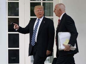 President Donald Trump walks with aide Keith Schiller to the Oval Office of the White House in Washington, Tuesday, May 2, 2017.