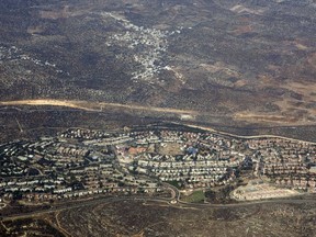 FILE - In this Sept. 20 2010 aerial file photo, taken through the window of an airplane shows the West Bank Jewish settlement of Ariel Weeks ahead of the expected completion of a U.N. database of companies that operate in Israel's West Bank settlements, Israel and the Trump Administration are working feverishly to prevent its publication. Dozens of major Israeli companies, and dozens of multinationals that do business in Israel, are expected to appear on the list. (AP Photo/Ariel Schalit, File)
