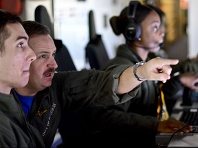 This photo provided by the Argentine Navy shows U.S. Navy members searching for Argentina's missing ARA San Juan submarine as they fly over the Southern Atlantic, after leaving a base in Bahia Blanca, Argentina, Monday, Nov. 27, 2017. The international search continues for the submarine carrying 44 crew members that has been lost in the South Atlantic since Nov. 15. (Argentina Navy via AP)