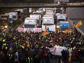 Demonstrators block a highway during a general strike in Borrassa, near Girona, Wednesday, Nov. 8, 2017. A worker's union has called for a general strike Wednesday in Catalonia. The regional government was sacked by Madrid and many of its members jailed in a rebellion probe after pushing ahead with secession from Spain. (AP Photo/Emilio Morenatti)