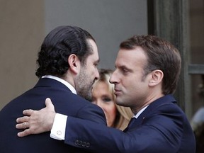 Lebanon's Prime Minister Saad Hariri, left, leaves after a lunch with French President Emmanuel Macron at the Elysee Palace in Paris, Saturday, Nov. 18, 2017. Hariri arrived in France on Saturday from Saudi Arabia and may be back in Beirut next week, seeking to dispel fears that he had been held against his will and forced to resign by Saudi authorities. (AP Photo/Christophe Ena)