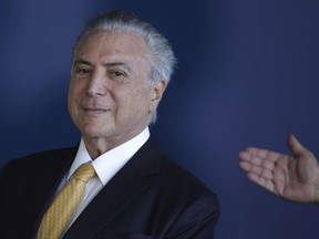 Brazil's President Michel Temer attends the swearing-in ceremony of his newly appointed Director-General of the Federal Police, Fernando Segovia, in Brasilia, Brazil, Monday, Nov. 20, 2017. Fernando Segovia was sworn in Monday by unpopular Brazilian President Michel Temer, who is himself being investigated by the force. (AP Photo/Eraldo Peres)