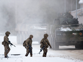 NATO soldiers take part in a military exercise in Lithuania in December 2016. An EU official says the PESCO pact would complement NATO’s security aims.