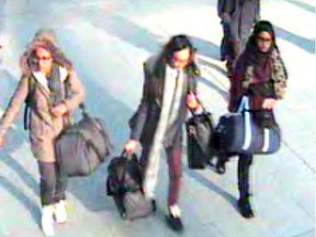 Closed circuit images show  (L-R) British teenagers Kadiza Sultana, Amira Abase and Shamima Begum passing through security barriers at Gatwick Airport, south of London, on February 17, 2015, enroute to joining the Islamic State group in Syria.