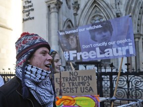 British national Lauri Love, who is accused of hacking into U.S. government computers, arrives for an extradition appeal hearing at the Royal Courts of Justice in London, Thursday, Nov. 30, 2017 while supporters stand outside. Authorities in America have been fighting for Love to face trial on charges of cyber-hacking, which lawyers have said could mean a sentence of up to 99 years in prison if he is found guilty. (AP Photo/Frank Augstein)