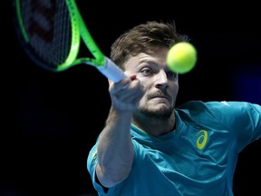 David Goffin of Belgium returns to Grigor Dimitrov of Bulgaria during their singles tennis match at the ATP World Finals at the O2 Arena in London, Wednesday, Nov. 15, 2017.(AP Photo/Frank Augstein)