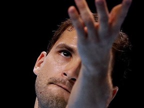 Grigor Dimitrov of Bulgaria serves to Dominic Thiem of Austria during their singles tennis match at the ATP World Finals at the O2 Arena in London, Monday, Nov. 13, 2017. (AP Photo/Kirsty Wigglesworth)