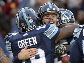 Toronto Argonauts quarterback Ricky Ray, right, celebrates with slotback S.J. Green during the second half of the East Division final on Nov. 19.