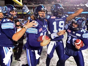Toronto Argonauts quarterback Ricky Ray, second from left, celebrates his team's Grey Cup win in Ottawa on Nov. 26.
