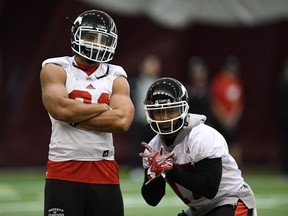 Calgary Stampeders running backs Anthony Woodson and Dominique Williams ham it up for the cameras at practice in Ottawa on Nov. 22.