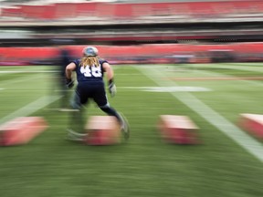 Toronto Argonauts linebacker Bear Woods runs through a drill during practice ahead of the 105th Grey Cup  game against the Calgary Stampeders in Ottawa on Friday, Nov. 24, 2017.