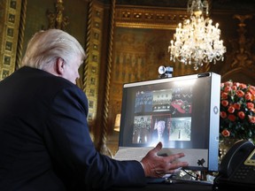 President Donald Trump speaks with members of the armed forces via video conference at his private club, Mar-a-Lago, on Thanksgiving, Thursday, Nov. 23, 2017, in Palm Beach, Fla. (AP Photo/Alex Brandon)